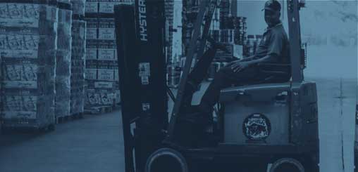 Warehouse crew loads orders onto trucks